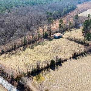 5 acres of fenced in pasture with a pond