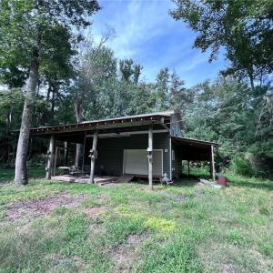 Two story barn with RV parking on the side.