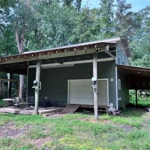 Two story barn with RV parking on the side.