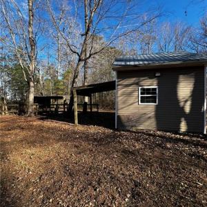 Utility shed with agricultural well and on stall horse barn.