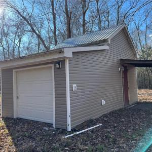 Utility shed with agricultural well and on stall horse barn.