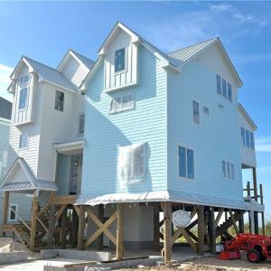 New construction home being built on neighboring lot