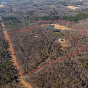 The locked red gate is located on Slate Mine Road.  This is a shared private road with 2 other property owners and the acreage for sale begins just after crossing under the powerlines ahead.