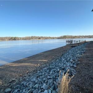 Rock riprap installed!  Temp draw down. Dock and boathouse are not included and located on lot next door NOT FOR SALE.