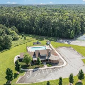 Clubhouse with pool, tennis courts, and basketball