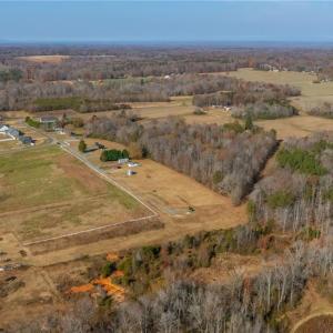 Left and back side of property is defined by a natural tree line.