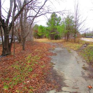 Paved asphalt drive at the entrance.