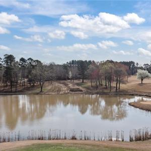 View of the lake and lot 54 at the center of the photo, with the 18th green and fairway to the right.