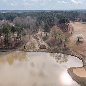 Overhead view showing the vacant lot 54 and the lake with the 18th green and fairway to the right.