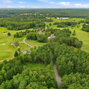Aerial view of the neighborhood and the golf course lot.