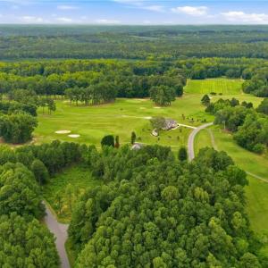 Aerial view of the neighborhood and the golf course lot.