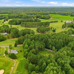 Aerial view of the neighborhood and the golf course lot.