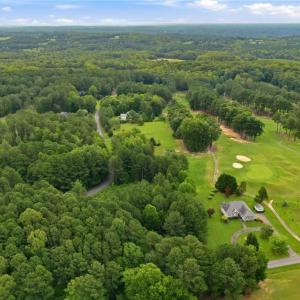 Aerial view of the neighborhood and the golf course lot.