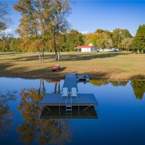 Stocked pond w/ floating dock