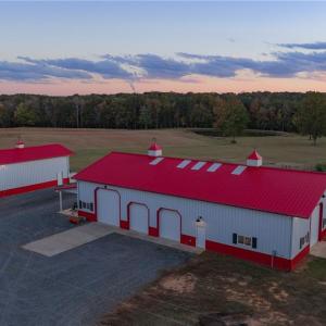 Equipment building w/ attached covered porches, built by Morton Buildings, 4 motorized garage doors, and ample space for equipment, storage, or hobby use