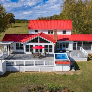 Large Trex style back deck, endless lap style pool (HydroDrive System), outdoor shower, direct access from the mudroom or great room, and views of rolling pasture and ponds