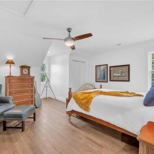 Large second floor guest bedroom with ceiling fan