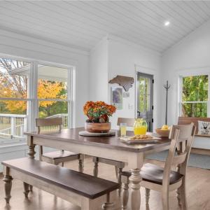 Open dining area adjacent to the kitchen & great room. Vaulted shiplap ceilings w/ exposed wood beams.