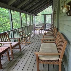 Screened porch facing the lake extends the length of the home