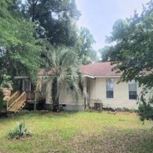 Back of house featuring a yard
