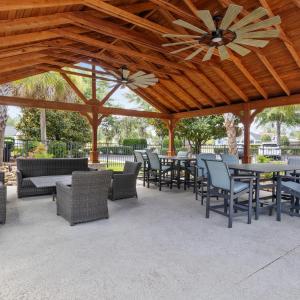 View of patio with ceiling fan and a gazebo