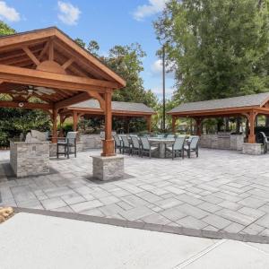 View of patio with a bar, a gazebo, ceiling fan, a