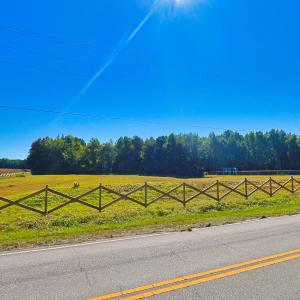 View of asphalt street with a rural view