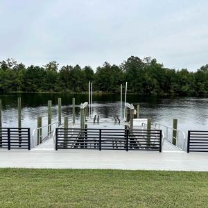 View of dock featuring a water view and a yard