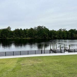 Exterior space with a lawn and a water view
