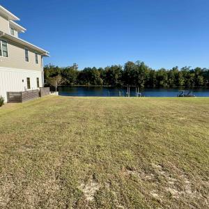 View of grassy yard with a water view