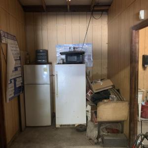 Kitchen with white refrigerator and wood walls