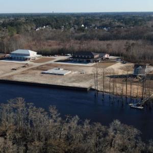 Birds eye view of property with a water view