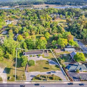 Birds eye view of property with a water view