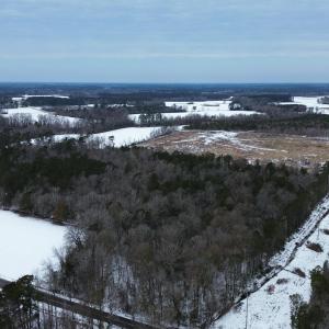 Snowy aerial view featuring a water view