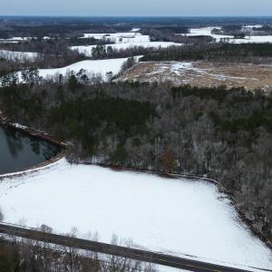 Snowy aerial view featuring a water view