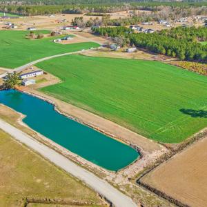 Drone / aerial view with a water view and a rural