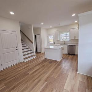 Kitchen featuring a center island, light counterto