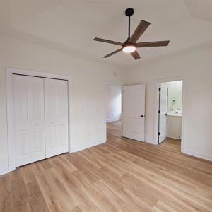 Unfurnished bedroom with ceiling fan, a closet, li