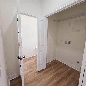 Clothes washing area with laundry area, wood finis