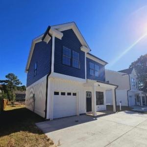 View of front of home featuring a garage, concrete