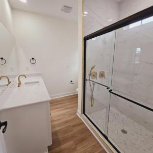 Bathroom featuring toilet, a marble finish shower,