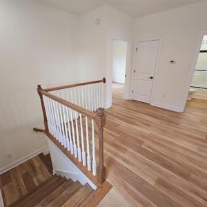 Stairs featuring baseboards and wood finished floo