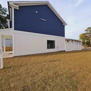 View of side of property featuring a yard