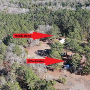 Aerial view featuring a wooded view