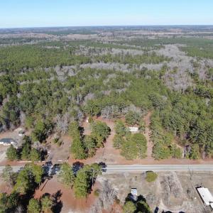 Birds eye view of property with a forest view