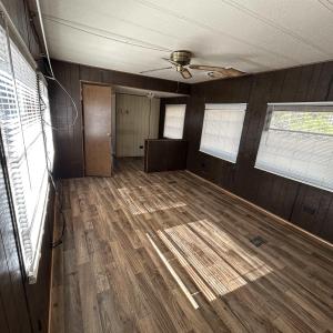 Empty room featuring dark wood-style floors, ceili