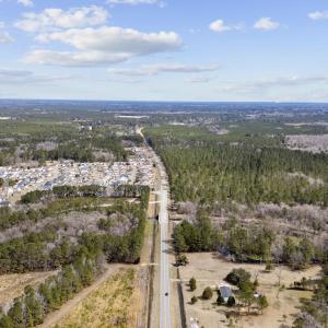 Birds eye view of property featuring a wooded view
