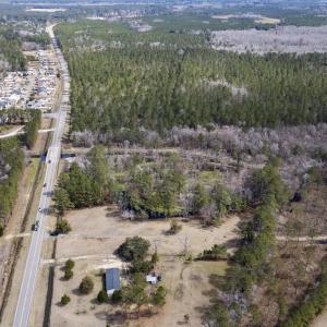 Birds eye view of property with a view of trees