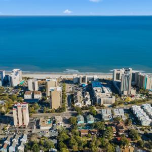Birds eye view of property with a water view and a