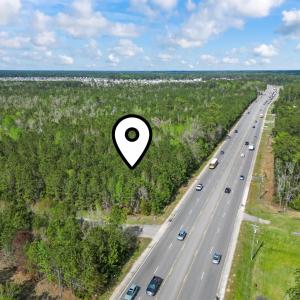Aerial view featuring a forest view